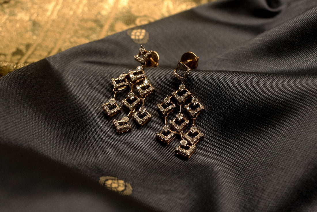 a group of gold and silver earrings