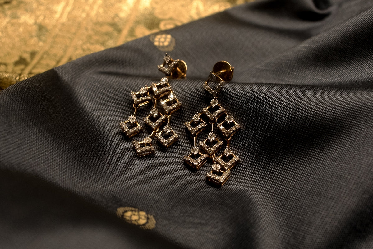 a group of gold and silver earrings